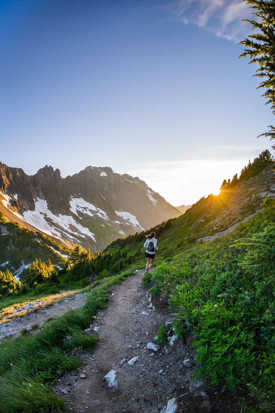Woman running up a mountain trail